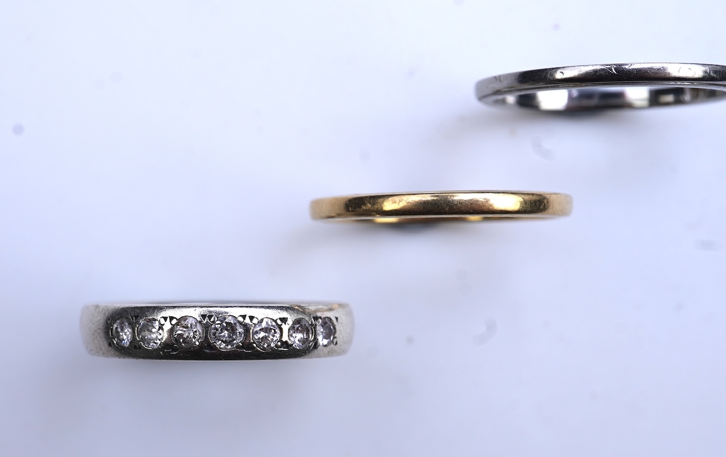 A diamond ring and two gold wedding rings
